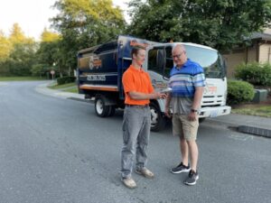 Johnson's Junk Removal professional explaining the single-item junk removal process to a happy customer