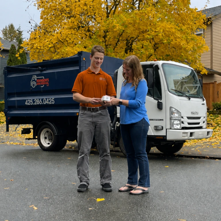 Junk removal professional quoting the cost of foreclosure cleanouts to a happy customer