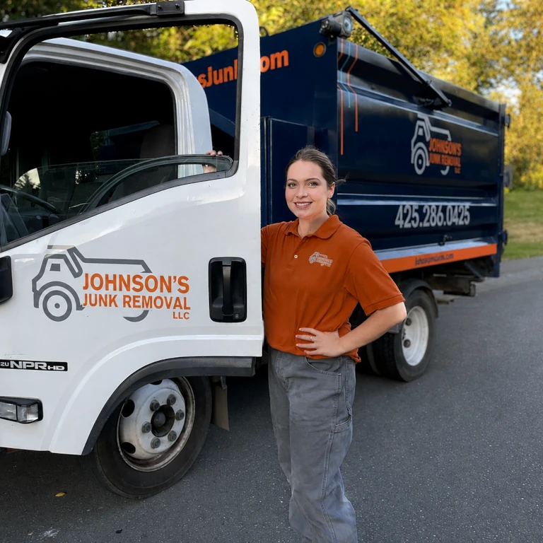 Johnson's Junk Removal professional smiling next to their truck