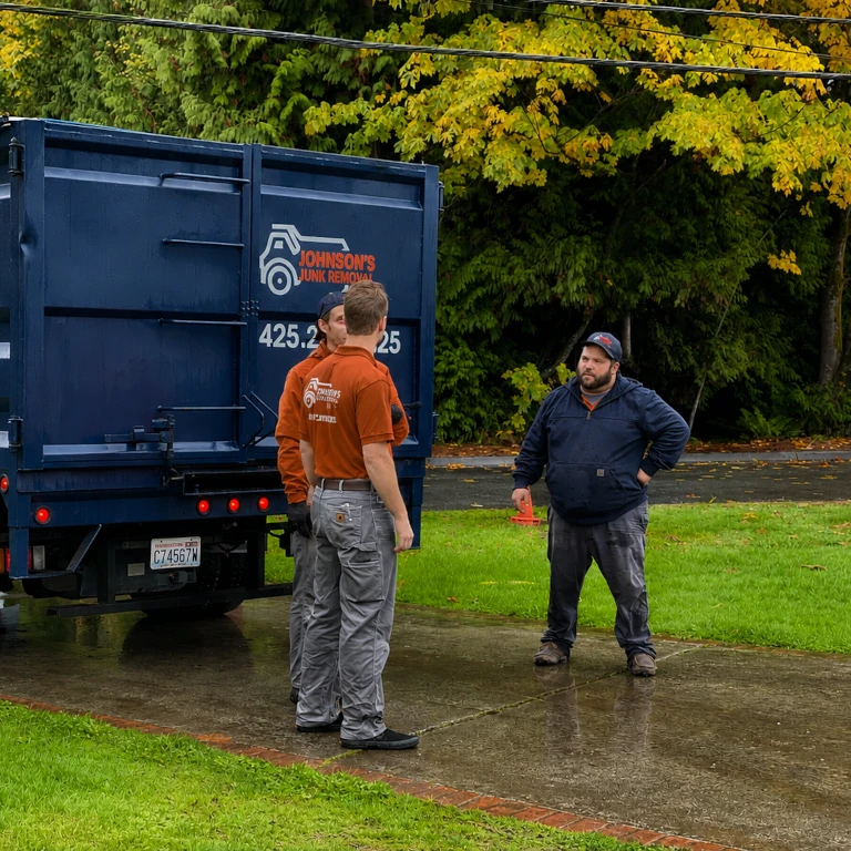 Junk removal professionals explaining the process of yard waste removal to a customer